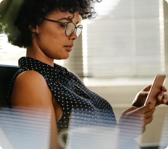 afro woman looking in her mobile